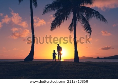 Happy mother son moment looking out to a beautiful ocean sunset. Parenting, and childhood family lifestyle concept. 