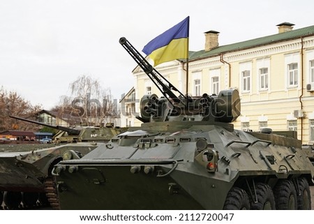 Army troops transporter and tank with Ukrainian flag, Ukraine - Russia war crisis concept, Kyiv Royalty-Free Stock Photo #2112720047