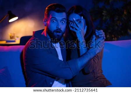 Photo of frightened fellows guy cuddle lady cove hands face cant see thriller series sit couch dark late flat