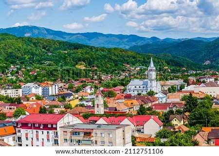 Aerial view of Baia Mare city with roof tops and the Catholic Cathedral in Baia Mare, Maramures, Romania; Assumption of Mary Cathedral or Saint Mary, the greek-catholic cathedral in Baia Mare Royalty-Free Stock Photo #2112751106