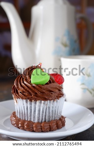 A cupcake is a small cake designed to serve one person, which may be baked in a small thin paper or aluminum cup. As with larger cakes, frosting and other cake decorations may be applied.