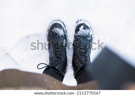 Top view of shoes in fresh snow. Winter season.