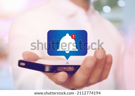 Alert Bell Notification on Smartphone on hand Royalty-Free Stock Photo #2112774194