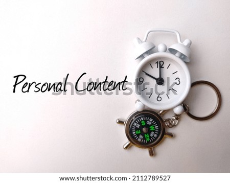 Top view compass and calculator with text Personal Content on white background.