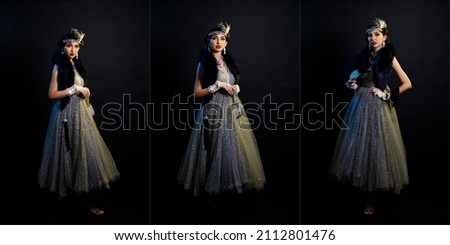Retro vintage portrait of beautiful Gatsby woman stand look around, wait coming train for lover, feeling expression face romantic fashion style at studio black background, full length body Royalty-Free Stock Photo #2112801476