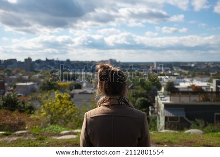 Woman overlooking view of Portland Maine from Fort Sumner Park