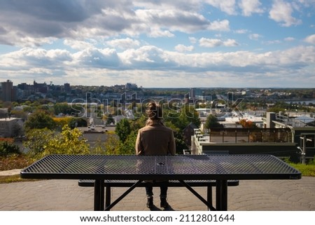 Woman overlooking view of Portland Maine from Fort Sumner Park