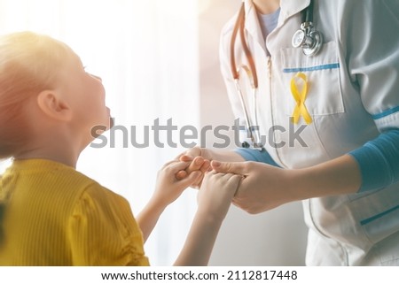 World Childhood cancer Day. Girl patient listening to a doctor in medical office. 