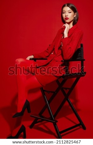 Fashion asian female model in red jacket and skirt. High fashion