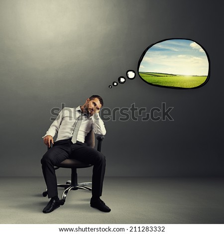 bored businessman sitting on the chair with speech bubble and thinking about rest over grey background