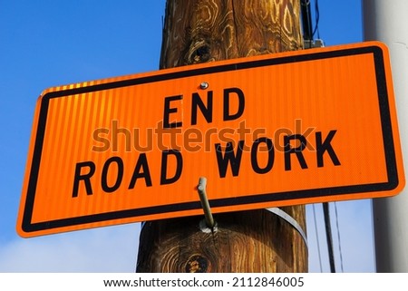Road work sign on telephone pole