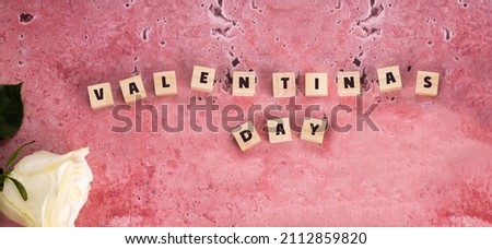 The phrase Happy Valentine's Day is posted on a pink background and a white rose next to it. valentine's day banner