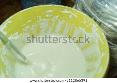 White putty in a bucket of water. Preparation of mortar for finishing walls and ceilings in the apartment. Repair in the house. DIY. Selective focus