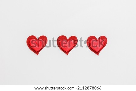 Composition with paper hearts on light background. St. Valentine's Day