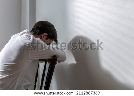 Male depression. Upset Asian young man got problem sitting alone at home, a lot of thoughts, break up with a lover or financial difficulties and debt Overthinking Unhappy unsatisfied and trouble idea. Royalty-Free Stock Photo #2112887369