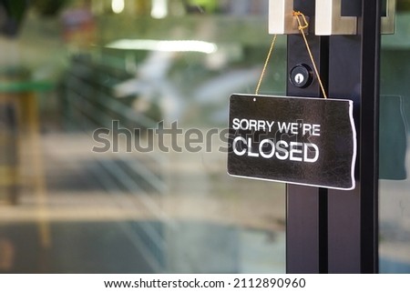 "sorry we're closed" label in front of glass door at the coffee shop to notice customer service                             