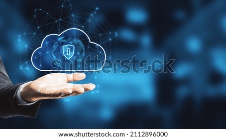 Close up of businessman hand holding abstract glowing cloud hologram with globe and safety icons, polygonal mesh on bokeh interior background with mock up place. 