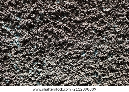 Photo of rough stucco wall surface.