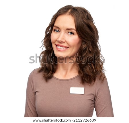 sale, shopping and business concept - happy female shop assistant with name tag over white background