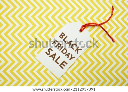 Black Friday Sale tag on yellow background