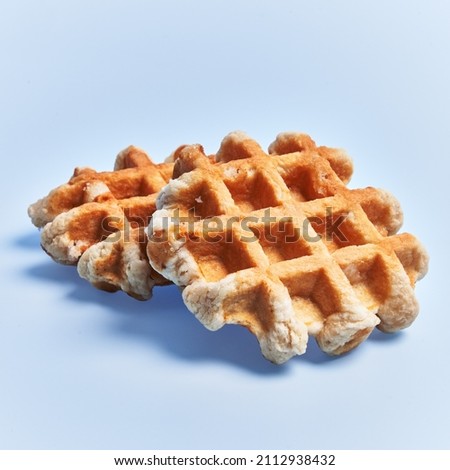  Single delicious waffle over blue background
