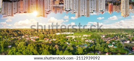 Rural versus urban areas. Beautiful landscape of country village from one side and city laldscape from other. Conceptual picture of increasing in the proportion  of cities. Royalty-Free Stock Photo #2112939092