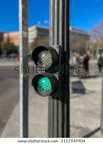 Traffic light with green light on indicating cars that they can circulate. Traffic light detail on a blurred background. Concept of circulation and traffic in the city.