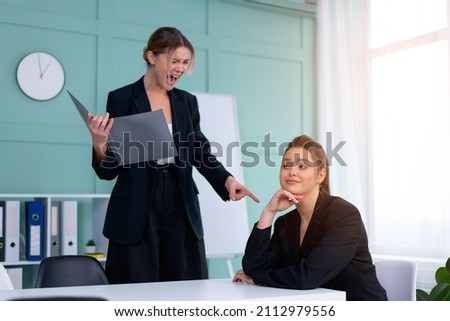 Boss screaming at frustrated employee, bullying and emotional abuse at work. Toxic work environment. Angry female irate boss yelling and shouting at his secretary employee. CEO rebuke for deadline Royalty-Free Stock Photo #2112979556