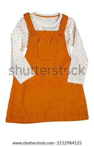 Summer dress isolated. Closeup of a beautiful orange baby girl dress and a white shirt with yellow polka dots isolated on a white background. Clipping path. Children spring fashion.