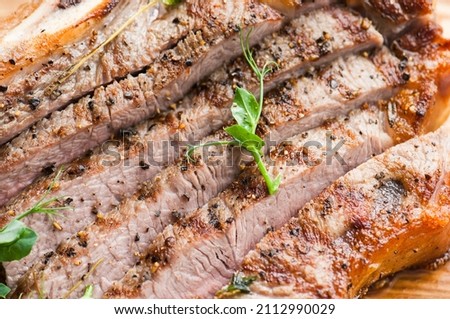 Grilled beef steak on wooden board. Close up.