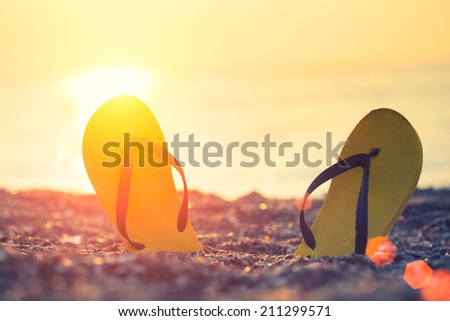 flip-flop on the beach  Royalty-Free Stock Photo #211299571