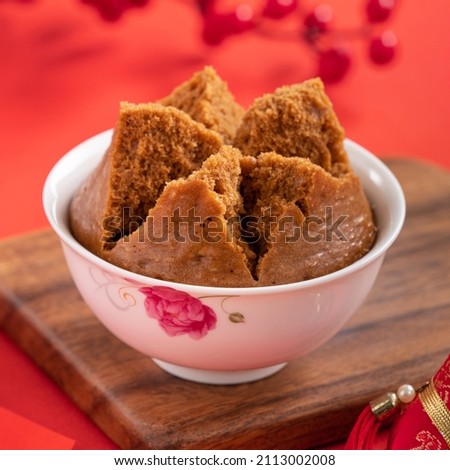 Close up of delicious Chinese steamed sponge cake named Fa Gao for lunar new year festival traditional food over red table background. Royalty-Free Stock Photo #2113002008