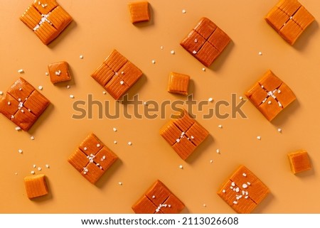 Homemade caramel candies pattern top view. Sweets background