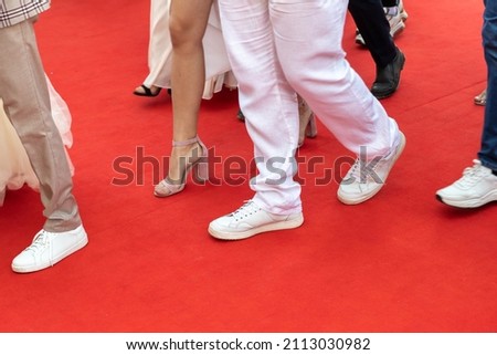 Feet of people walking on the red carpet, close up photo