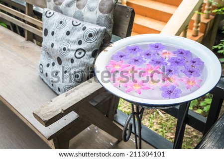 Floating flowers in metallic basin, decorated in the garden