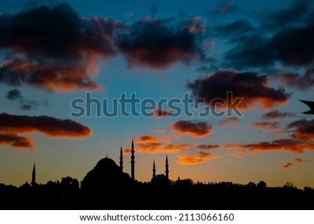 Islamic background photo. Silhouette of Mosque and cityscape of Istanbul at sunset. Ramadan or iftar or kandil or laylat al-qadr or islamic background. Selective focus on building. noise included.