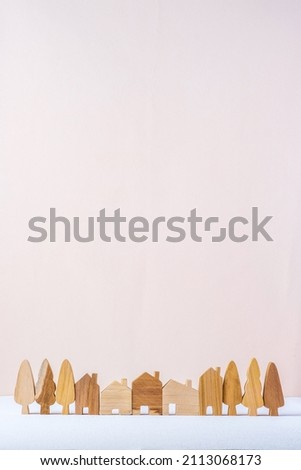 group of wood home toy village shape on white table peach background