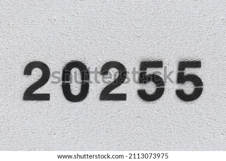 Black Number 20255 on the white wall. Spray paint.two thousand two hundred fifty fivetwo thousand two hundred fifty five