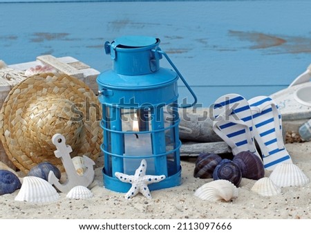 Maritime decoration: lantern, starfish, shells and flip flop shoes. Royalty-Free Stock Photo #2113097666