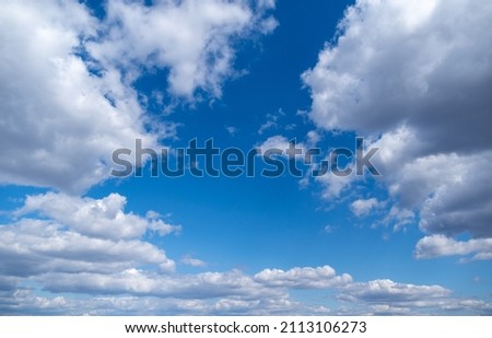 Stock color photography of clear sunny blue sky with beautiful delicate soft fluffy white clouds moving along sky. Natural video background
