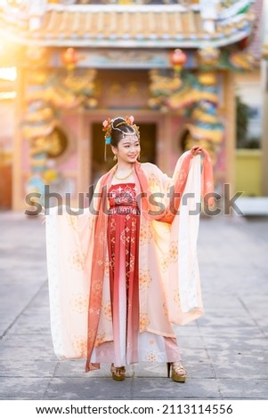 Portrait smile Cute little Asian girl wearing Chinese costumes decoration for Chinese new year festival celebrate culture of china at Chinese shrine Public places in Thailand