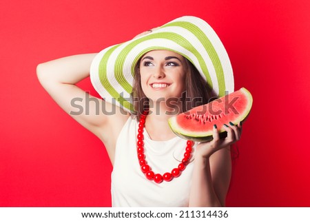 beautiful young woman holding watermelon against red background