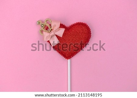 Valentine day greeting concept with red heart decoration on bright pink background top view, copy space. Flat lay 