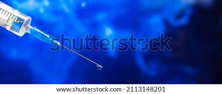 Coronavirus coivd-19 and omicron variant background. Syringe needle close-up, world epidemic and vaccination concept Royalty-Free Stock Photo #2113148201