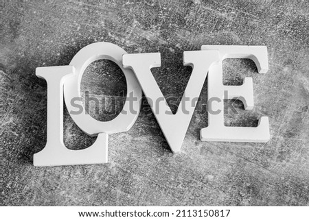 Word LOVE on a gray background.
