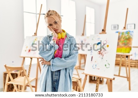 Young caucasian girl at art studio thinking looking tired and bored with depression problems with crossed arms. 