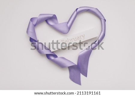 Heart shape made of ribbon on white background. Valentines and 8 March Mother Women's Day concept