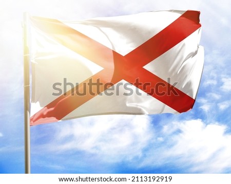 Flagpole with flag of State of Alabama.
