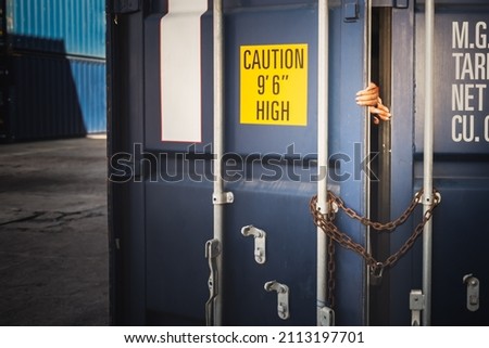 The door of a container which was covered with iron chains and keys, inside of which several people, to human trafficking and illegal immigration concept. Royalty-Free Stock Photo #2113197701