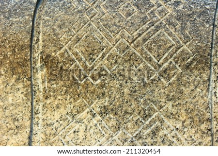 on a stone carved ethnic pattern in the form of diamonds